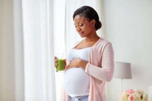 Pregnant Woman Holding Glass of Juice